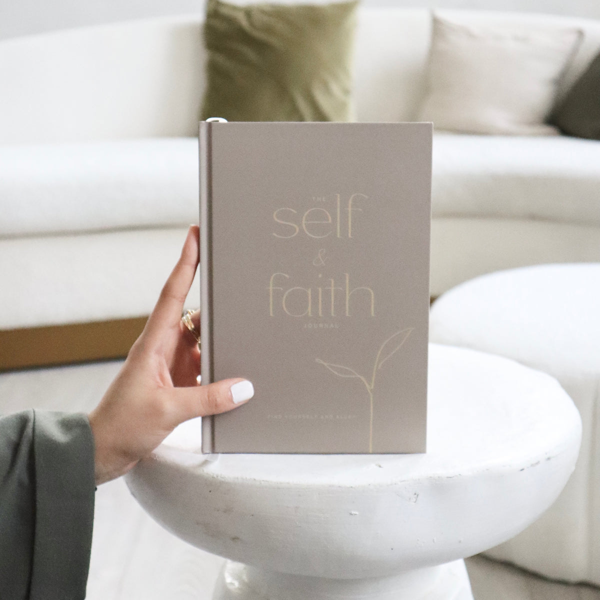Hand holding The Self and Faith Journal Vanilla Latte - guided Islamic journal for spiritual growth and self-reflection #color_vanilla-latte