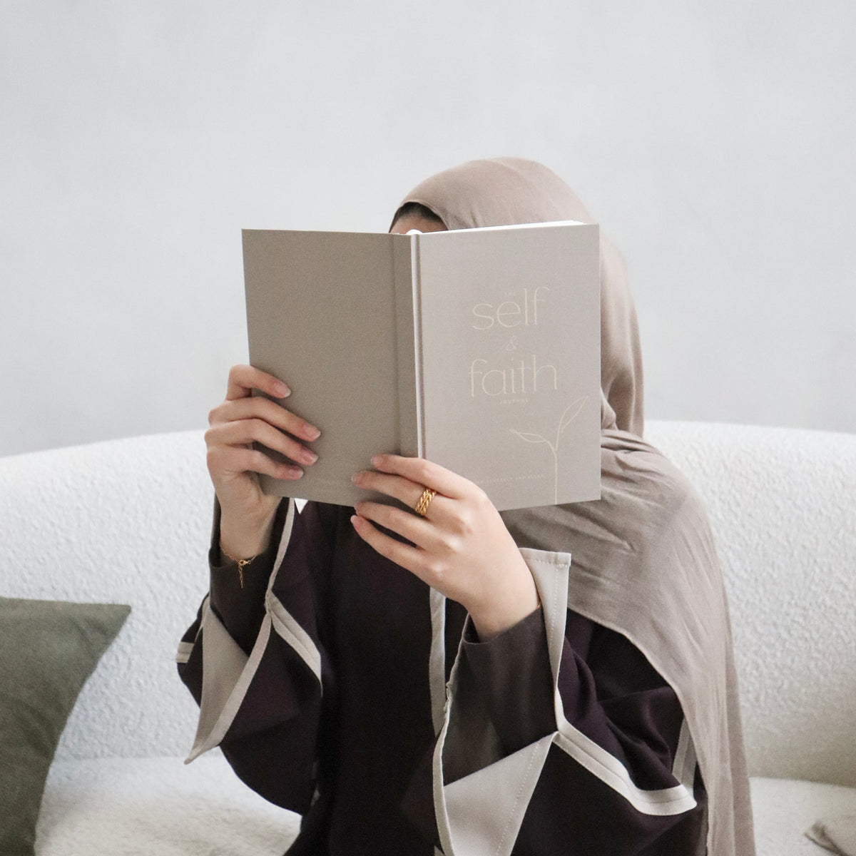 Muslim woman holding The Self and Faith Journal Vanilla Latte - 90-day guided Islamic journal lifestyle photo #color_vanilla-latte