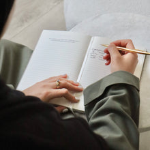Person writing in The Self and Faith Journal Vanilla Latte with gold pen - daily Islamic journaling in practice #color_vanilla-latte