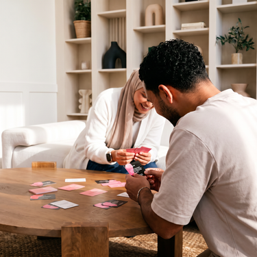 A Muslim couple playing the intention. conversation card game at home