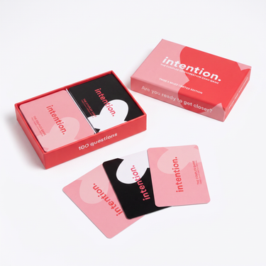 intention. card game open, showing the 100 pink and black couples conversation cards